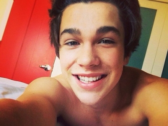 Austin Mahone, unrecognizable in the new clip. The artist released "MMM Yeah" feat. Pitbull - Lyric Video